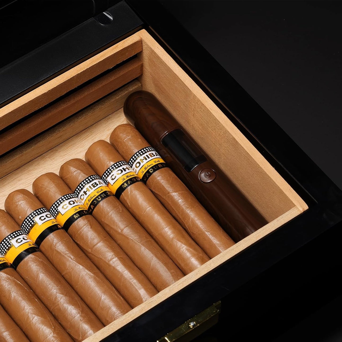 Cigars and cigar-shape humidity tester in a humidor